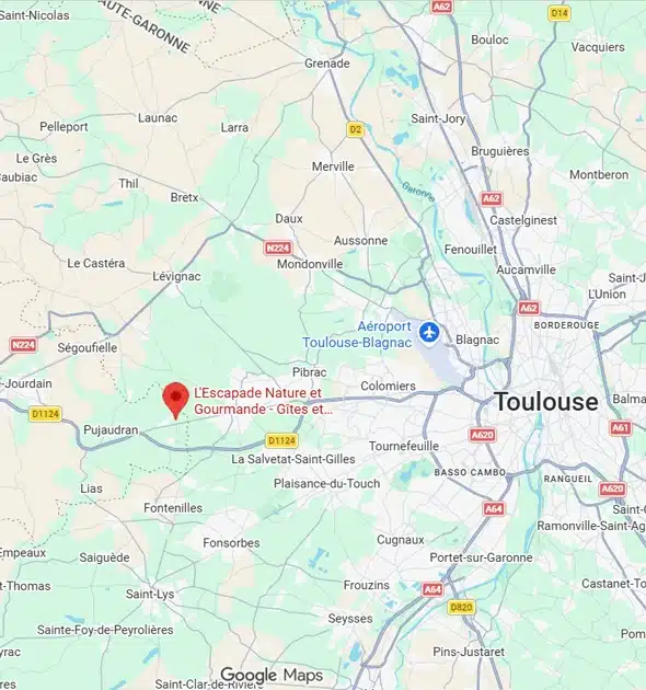 Une carte montrant la région à l'ouest de Toulouse, France, avec une punaise rouge marquant LEscapade Nature et Gourmande près de Pibrac et Pujaudran. Les routes principales, les villes et l'aéroport de Toulouse-Blagnac sont indiqués.
